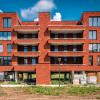Een voorgeval van een gebouw met rode gevels in De Boterton in Lier | DCA Bouw